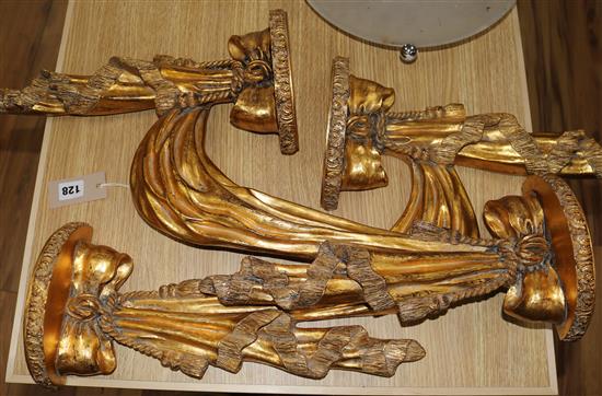 A pair of gilt shelf brackets